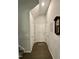 Light-filled hallway showcasing a charming grandfather clock and paneled doors at 1113 Hudson Dr, Mebane, NC 27302