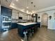 Modern kitchen boasts a large island, sleek countertops, pendant lighting, and stainless steel appliances at 1113 Hudson Dr, Mebane, NC 27302