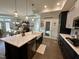 Open concept kitchen with center island, white countertops, stainless steel appliances, and wood flooring at 1113 Hudson Dr, Mebane, NC 27302