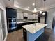 Updated kitchen featuring a large island with marble countertops, stainless steel appliances, and designer finishes at 1113 Hudson Dr, Mebane, NC 27302