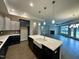 Open kitchen featuring an island with quartz countertop, stainless steel appliances, and hardwood floors at 1113 Hudson Dr, Mebane, NC 27302