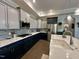 Elegant kitchen showcasing two-tone cabinetry, stainless steel appliances, and a stylish backsplash at 1113 Hudson Dr, Mebane, NC 27302