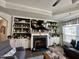 Cozy living room with a fireplace, built-in shelving, and comfortable seating area at 1113 Hudson Dr, Mebane, NC 27302