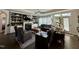 Comfortable living room with fireplace, built-in shelves, a ceiling fan, and large windows for natural light at 1113 Hudson Dr, Mebane, NC 27302