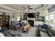 Cozy living room featuring a fireplace, built-in shelving, ceiling fan, and comfortable seating at 1113 Hudson Dr, Mebane, NC 27302