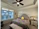 Beautifully decorated bedroom featuring a queen-sized bed, ceiling fan and large bright window at 1113 Hudson Dr, Mebane, NC 27302