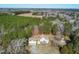 Stunning aerial view of home surrounded by lush green trees with multiple car garage and large yard at 1175 Faulkner Town Rd, Henderson, NC 27537