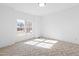 Bright bedroom featuring a large window, neutral carpet, and light walls at 1175 Faulkner Town Rd, Henderson, NC 27537