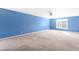 A blue bedroom with neutral carpet, ceiling fan, and a window with blinds at 1175 Faulkner Town Rd, Henderson, NC 27537