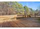 Spacious wooden deck featuring railing, perfect for outdoor living and enjoying the surrounding landscape at 1175 Faulkner Town Rd, Henderson, NC 27537