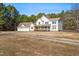 Charming two-story home featuring a spacious front porch and a detached three-car garage with ample parking at 1175 Faulkner Town Rd, Henderson, NC 27537