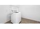 A white washing machine in a laundry room with tile floors at 1175 Faulkner Town Rd, Henderson, NC 27537
