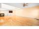 Open concept living space with hardwood floors, fireplace, and a view into the kitchen at 1175 Faulkner Town Rd, Henderson, NC 27537