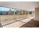 Relaxing covered porch with wooden floors and white railings offering a serene outdoor space at 1175 Faulkner Town Rd, Henderson, NC 27537