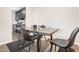 Dining area features a modern table and chairs on top of a neutral area rug at 1287 Schaub Dr # J, Raleigh, NC 27606