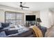 Bright living room featuring a ceiling fan, large sliding glass doors, and comfortable seating at 1287 Schaub Dr # J, Raleigh, NC 27606