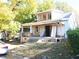Shows a two-story home with a porch and a new room and windows upstairs at 1404 Gearwood Ave, Durham, NC 27701