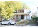 Shows a two-story home with a porch, new windows upstairs, and a car parked on the side of the house at 1404 Gearwood Ave, Durham, NC 27701