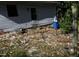Shows the back of the house with white siding, an added room upstairs, and leaves in the yard at 1404 Gearwood Ave, Durham, NC 27701
