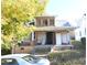 Shows a two-story home with a porch and a new room and windows upstairs at 1404 Gearwood Ave, Durham, NC 27701
