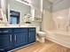 Bathroom featuring stylish blue vanity, white countertop, and a shower-tub combination at 1522 Kudrow Ln, Morrisville, NC 27560