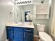 Bathroom featuring stylish blue vanity, white countertop, and decor accents at 1522 Kudrow Ln, Morrisville, NC 27560