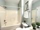 Bathroom featuring a tub with shower and decorative plants for an added touch of elegance at 1522 Kudrow Ln, Morrisville, NC 27560