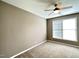 Bedroom featuring neutral walls, plush carpeting, ceiling fan and bright window at 1522 Kudrow Ln, Morrisville, NC 27560