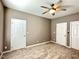 Bedroom featuring neutral walls, plush carpeting, and two entry doorways at 1522 Kudrow Ln, Morrisville, NC 27560