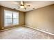 Bedroom with neutral walls, plush carpeting, and a ceiling fan for added comfort at 1522 Kudrow Ln, Morrisville, NC 27560