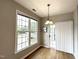 Bright dining room featuring modern lighting, large windows and access to the balcony at 1522 Kudrow Ln, Morrisville, NC 27560