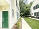 Exterior of condo shows a green door, green shutters, and well-maintained landscaping at 1522 Kudrow Ln, Morrisville, NC 27560