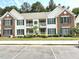 Attractive condo building with a mix of brick and siding, featuring green shutters and well-maintained landscaping at 1522 Kudrow Ln, Morrisville, NC 27560