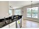 Kitchen and bar area featuring granite countertops, stainless steel appliances, and hardwood floors at 1522 Kudrow Ln, Morrisville, NC 27560