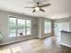 Spacious living room with hardwood floors, ceiling fan, and large windows at 1522 Kudrow Ln, Morrisville, NC 27560