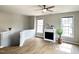 Bright living room with fireplace, ceiling fan, and hardwood floors at 1522 Kudrow Ln, Morrisville, NC 27560