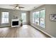 Bright living room with hardwood floors, many windows and fireplace at 1522 Kudrow Ln, Morrisville, NC 27560