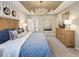 Bedroom featuring a decorative ceiling, bed with plush bedding, wood dresser, and stylish furnishings at 1712 Red Roses Ave, Durham, NC 27703