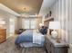 Well-lit bedroom featuring a decorative ceiling, a large bed with plush bedding, and stylish furnishings at 1712 Red Roses Ave, Durham, NC 27703