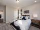 Stylish bedroom featuring unique décor, a patterned comforter, carpet flooring, and a side table at 1712 Red Roses Ave, Durham, NC 27703