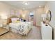Bright bedroom with a colorful floral comforter, plush carpet, and an abundance of natural light at 1712 Red Roses Ave, Durham, NC 27703