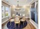 Elegant dining room featuring a round wood table, stylish chairs, decorative lighting, and an accent rug at 1712 Red Roses Ave, Durham, NC 27703