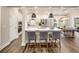 Modern kitchen with white cabinets, stainless steel appliances, a quartz countertop island, and a dining area at 1712 Red Roses Ave, Durham, NC 27703