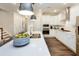 Bright kitchen featuring white cabinets, stainless steel appliances, a large island, and modern pendant lighting at 1712 Red Roses Ave, Durham, NC 27703