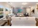 Inviting living room featuring hardwood floors, neutral-toned furnishings, large windows, and stylish decor at 1712 Red Roses Ave, Durham, NC 27703