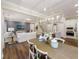 Open-concept living space showcasing hardwood floors, contemporary lighting, and a seamless transition to the kitchen at 1712 Red Roses Ave, Durham, NC 27703