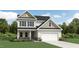 Charming two-story home featuring stone accents, vertical siding, and an attached two-car garage at 1800 Red Roses Ave, Durham, NC 27703