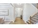 Open-concept interior featuring wood floors, white walls, and stairs with a railing at 1800 Red Roses Ave, Durham, NC 27703