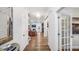 Bright hallway leads to an open-concept living area, showcasing hardwood floors and a view of the living room at 1800 Red Roses Ave, Durham, NC 27703