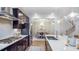 Bright kitchen with stainless steel appliances, dark cabinets, white countertops, and a view to the dining room at 1800 Red Roses Ave, Durham, NC 27703